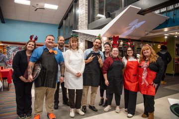Staff ready to serve students at the 2025 Holiday Dinner.